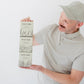 Paul the founder of Jack Be Nimble holding a candle boxes with a white background