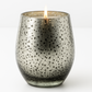 Lit Dark Orchard Mercury Glass Candle with silver speckled finish on white background